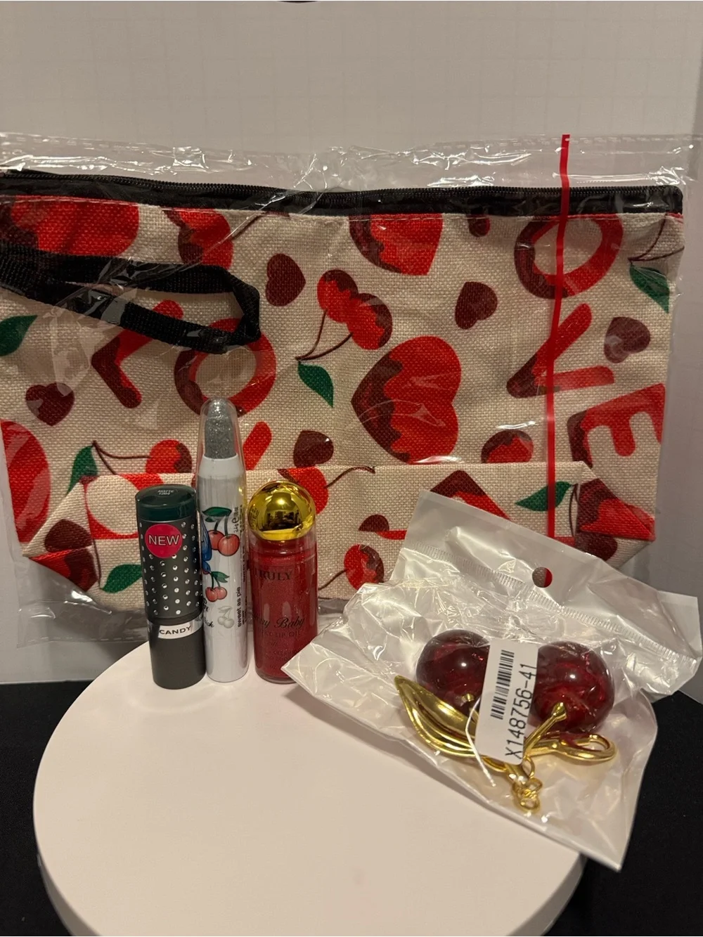 Cherry Print Cosmetic Bag with Cherry keychain and hard candy makeup, truly lip